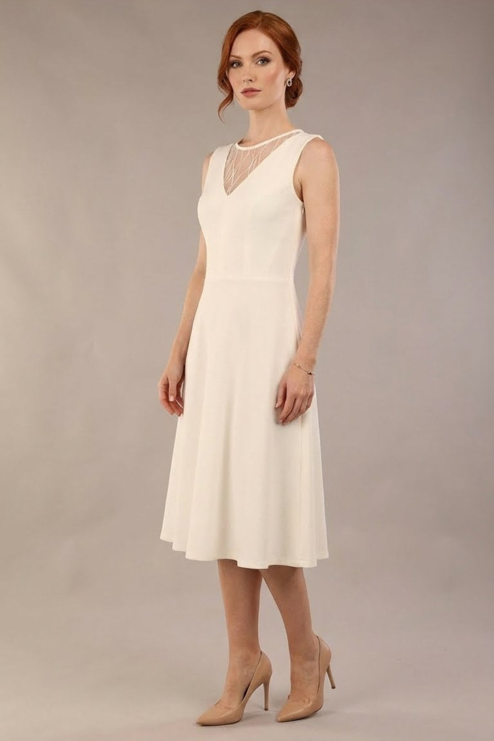 model wearing Diva Catwalk Patina A-line Swing Sleeveless dress with v-neckline with detail in Ivory-White colour (Ivory and Ivory)