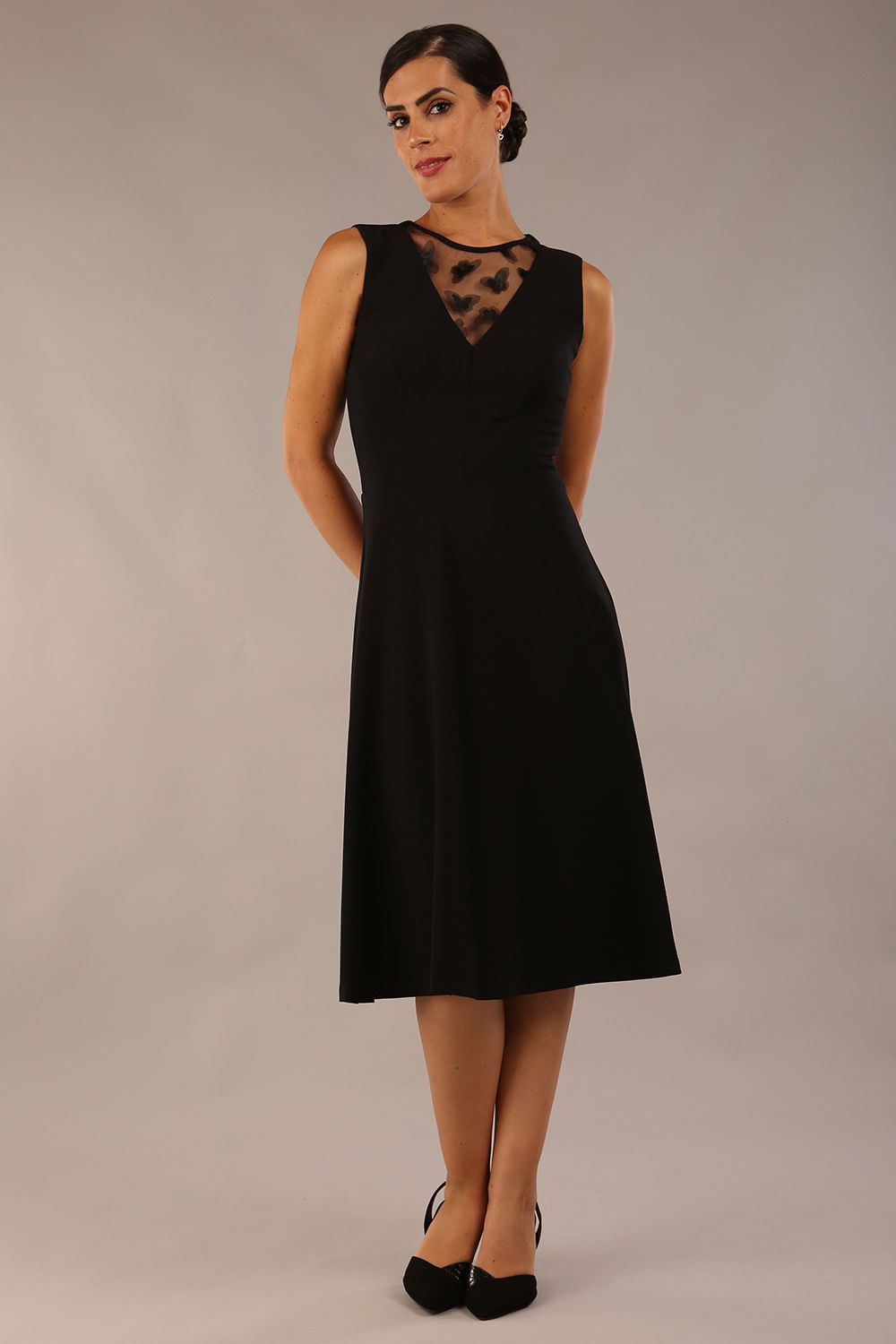 model wearing Diva Catwalk Patina A-line Swing Sleeveless dress with v-neckline with butterfly detail in Black front