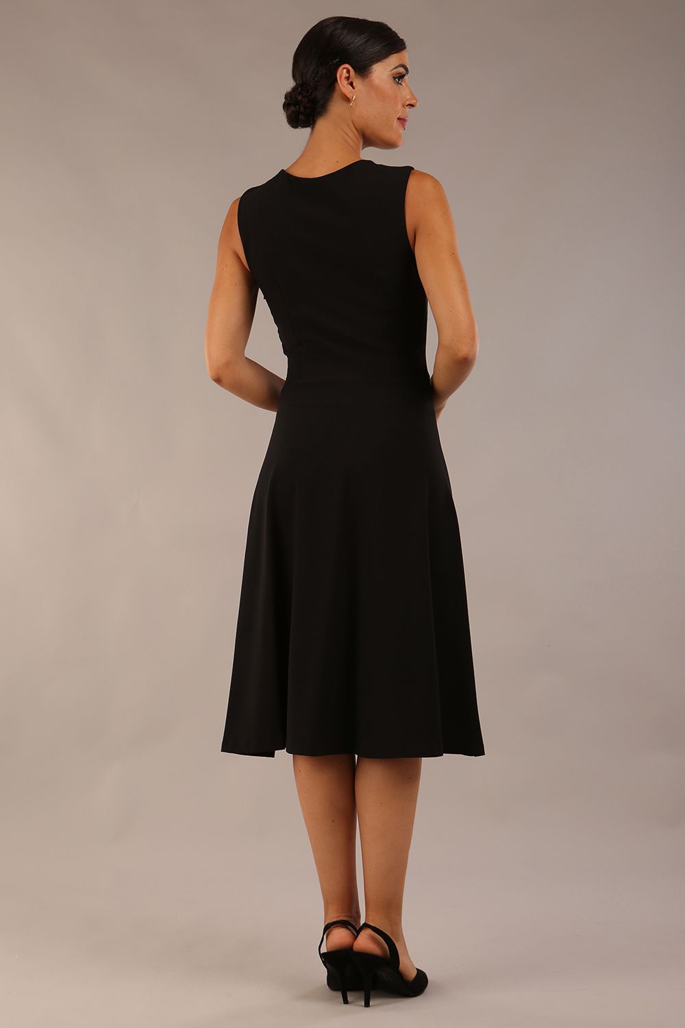 model wearing Diva Catwalk Patina A-line Swing Sleeveless dress with v-neckline with butterfly detail in Black back