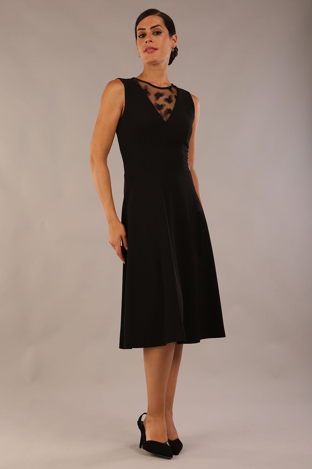 model wearing Diva Catwalk Patina A-line Swing Sleeveless dress with v-neckline with butterfly detail in Black front