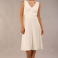 model wearing Diva Catwalk Patina A-line Swing Sleeveless dress with v-neckline with detail in Ivory-White colour 