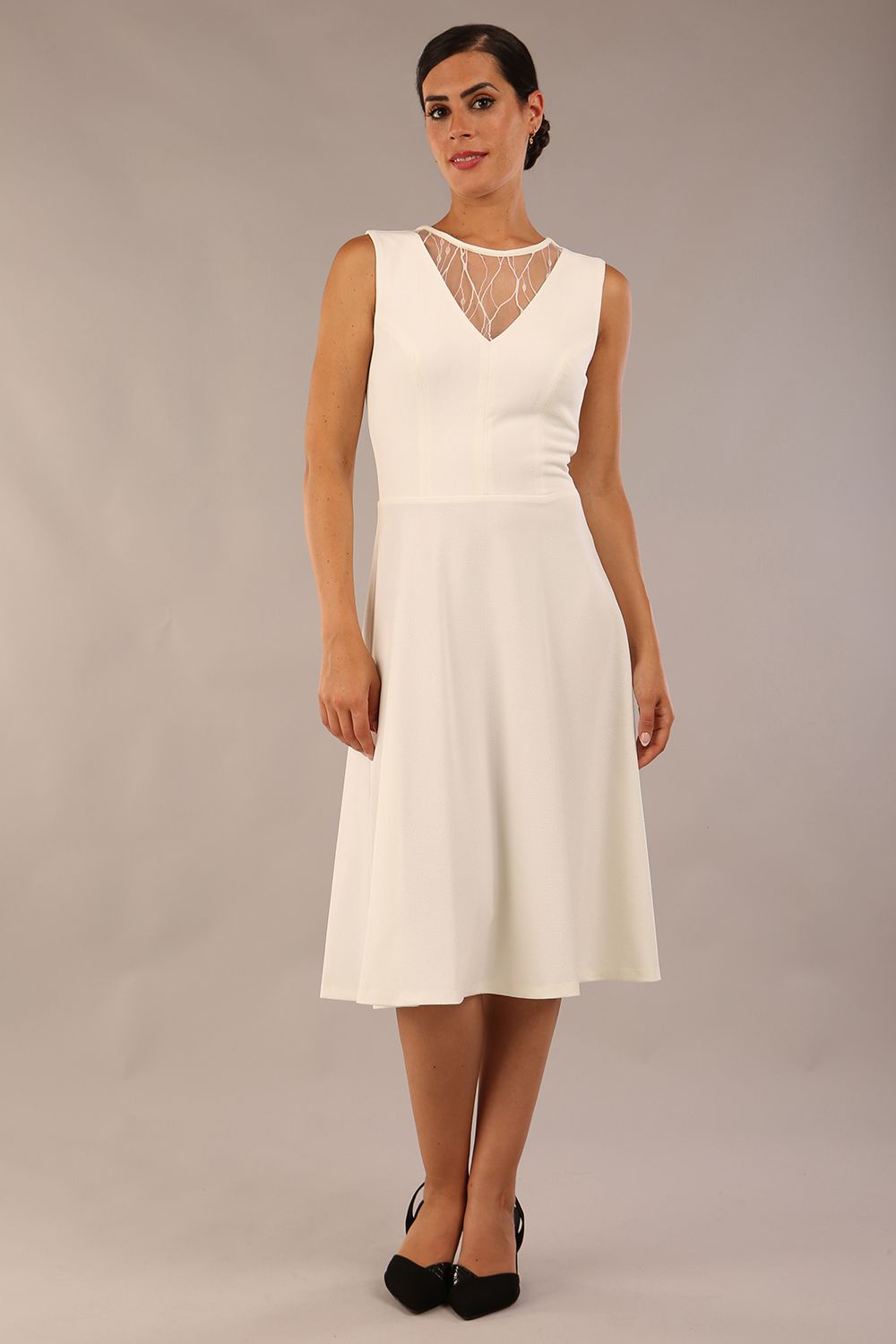 model wearing Diva Catwalk Patina A-line Swing Sleeveless dress with v-neckline with detail in Ivory-White colour 