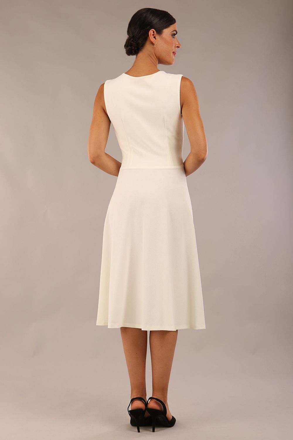 model wearing Diva Catwalk Patina A-line Swing Sleeveless dress with v-neckline with detail in Ivory-White colour back