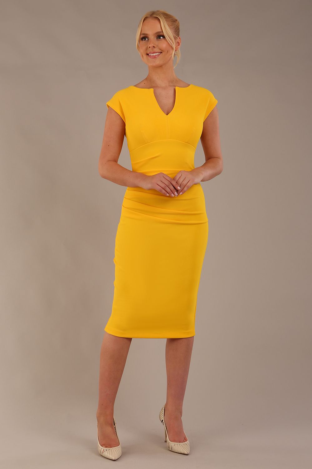 model wearing diva catwalk lydia sleeveless pencil flattering fitted plain dress with split neckline and pleating across the body in spectra yellow front (Spectra Yellow)