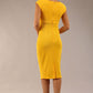 brunette model wearing diva catwalk lydia sleeveless pencil flattering fitted plain dress with split neckline and pleating across the body in spectra yellow back