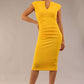 brunette model wearing diva catwalk lydia sleeveless pencil flattering fitted plain dress with split neckline and pleating across the body in spectra yellow front