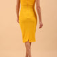 brunette model wearing diva catwalk lydia sleeveless pencil flattering fitted plain dress with split neckline and pleating across the body in spectra yellow back