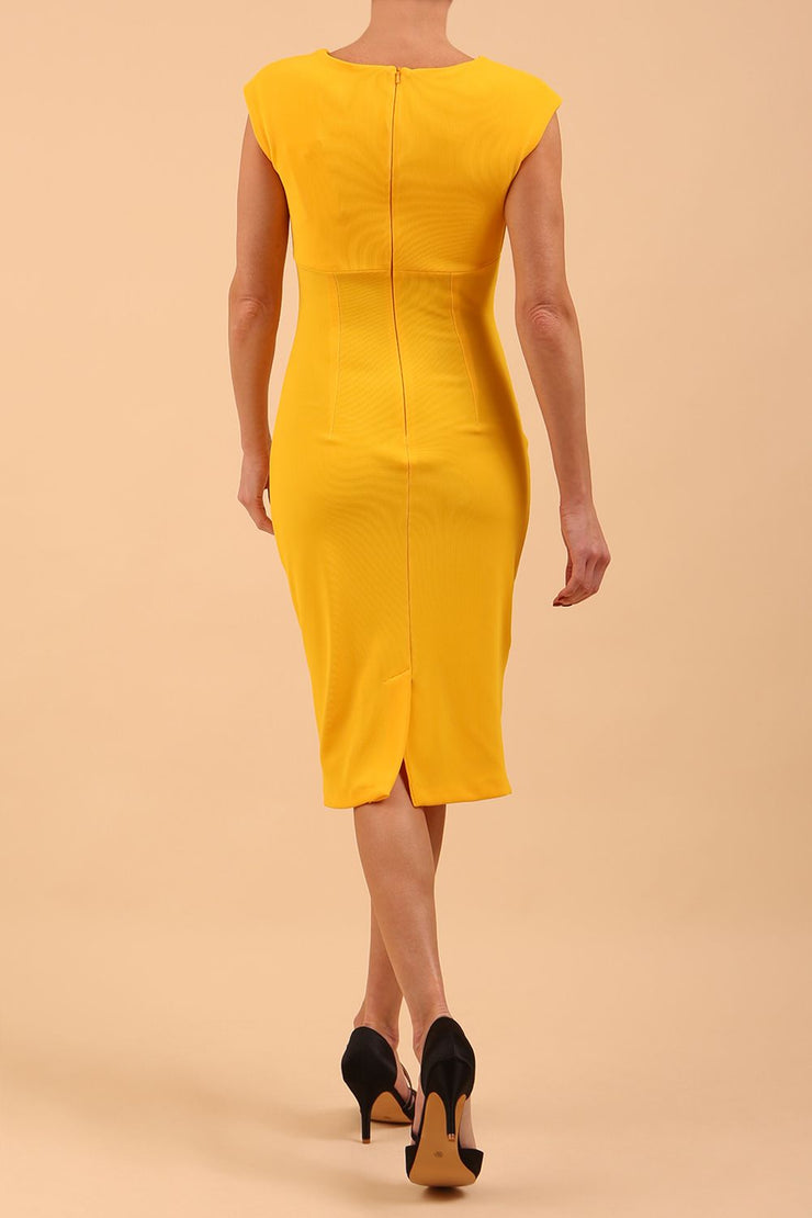 brunette model wearing diva catwalk lydia sleeveless pencil flattering fitted plain dress with split neckline and pleating across the body in spectra yellow back