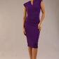 brunette model wearing diva catwalk lydia sleeveless pencil flattering fitted plain dress with split neckline and pleating across the body passion purple front