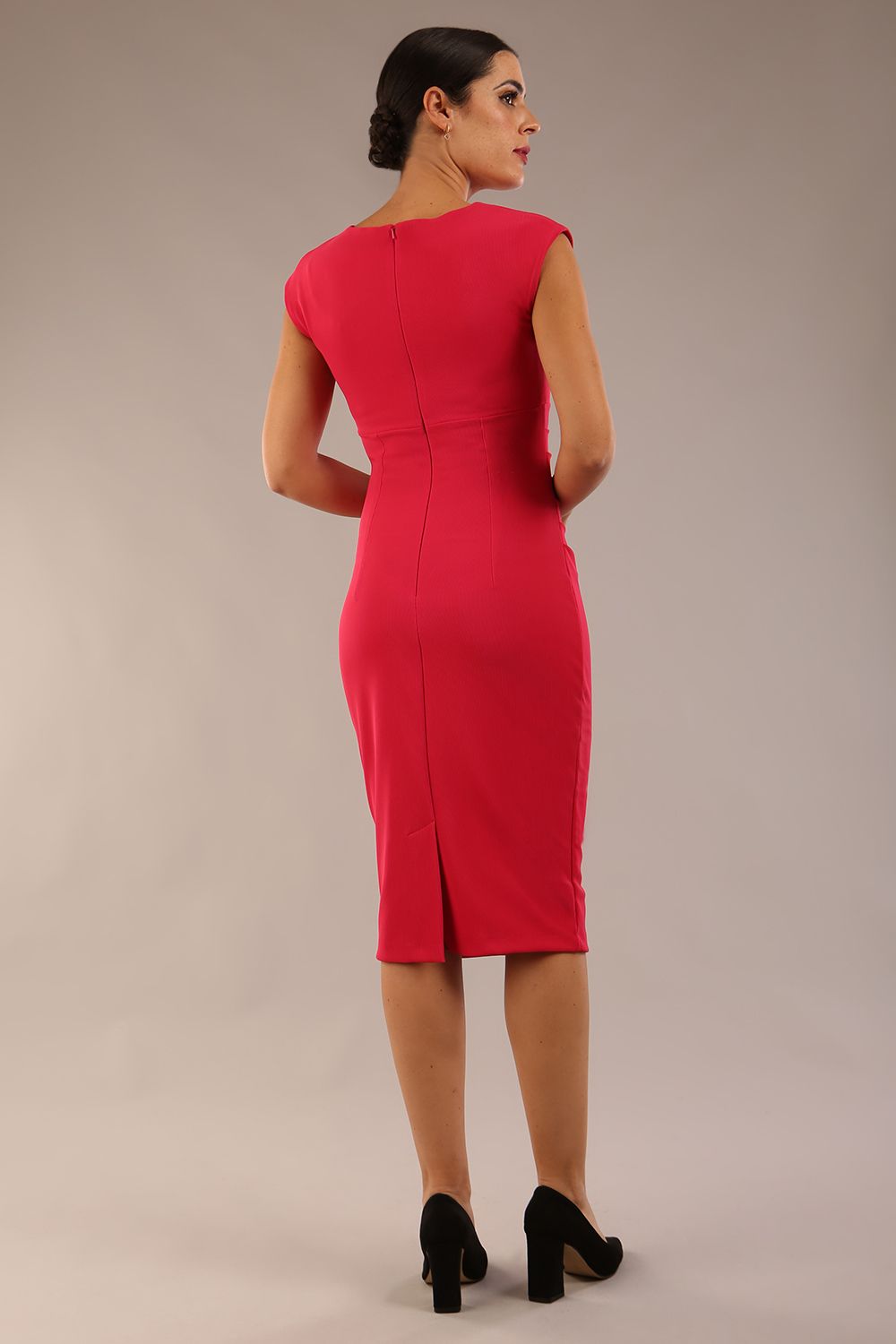 brunette model wearing diva catwalk lydia sleeveless pencil flattering fitted plain dress with split neckline and pleating across the body Raspberry pink back