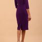 model wearing Diva Catwalk pencil three quarter sleeve dress with a split neckline and pleating across the tummy in passion purple back