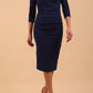 model wearing Diva Catwalk pencil three quarter sleeve dress with a split neckline and pleating across the tummy in navy Blue front