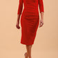 model wearing Diva Catwalk pencil three quarter sleeve dress with a split neckline and pleating across the tummy in true red front