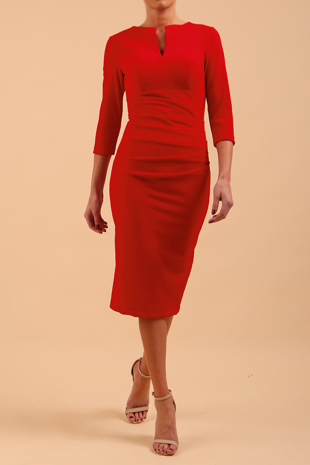 model wearing Diva Catwalk pencil three quarter sleeve dress with a split neckline and pleating across the tummy in true red front