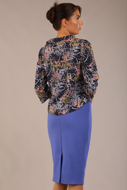 brunette model wearing a diva catwalk seed elixir pencil knee length skirt in thistle blue back