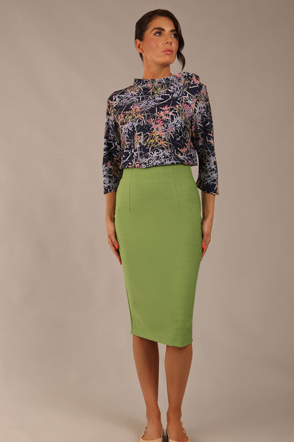 brunette model wearing a diva catwalk seed elixir pencil knee length skirt in citrus green front 