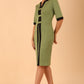 brunette model wearing Diva catwalk goggle pencil dress with short sleeve and v-neckline with contrasted design across body in dill green front