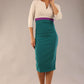 brunette model wearing seed lara pencil colour block dress three quarter sleeve and pleating across the body with split neckline in Pacific green and sandy cream and amethyst purple front