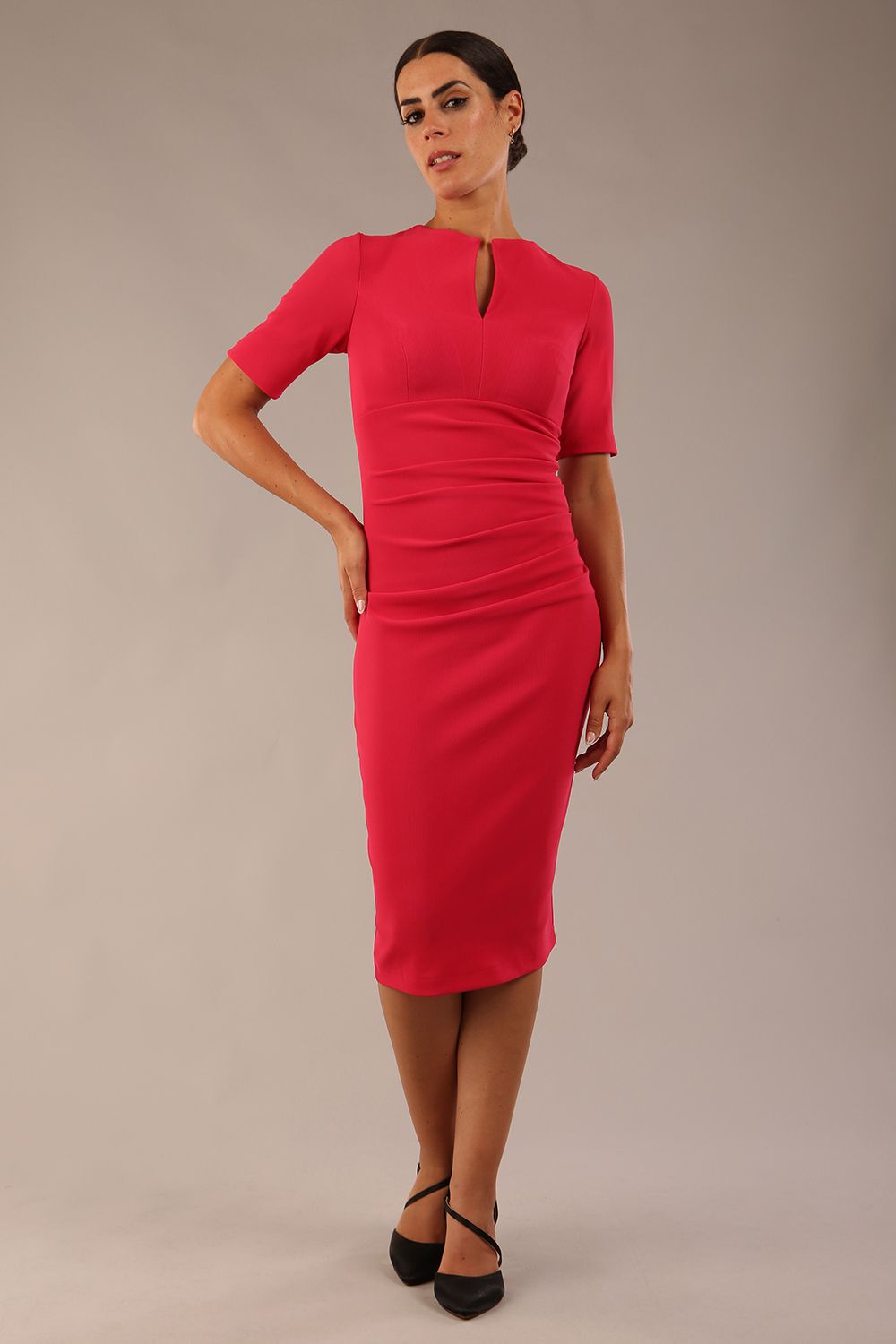 model is wearing Diva Catwalk Lydia Short Sleeve Pencil Dress with pleating across the tummy and split neckline in Raspberry Pink front