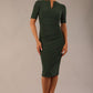 model is wearing diva catwalk lydia short sleeve pencil fitted dress in deep green colour with rounded neckline with a slit in the middle front