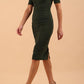 model is wearing Diva Catwalk Lydia Short Sleeve Pencil Dress with pleating across the tummy and split neckline in Deep Green front side