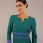 Model wearing Diva catwalk Paeonia dress square neckline with a vent in Pacific Green with Thistle Blue and Pacific Green stripes around the waist and three quarter sleeve with Thistle Blue contrast finish front close up