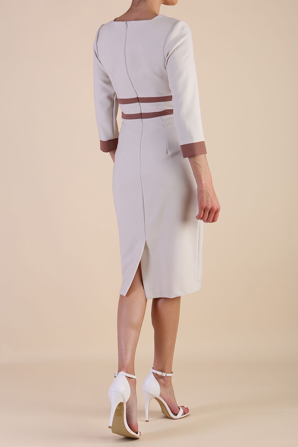brunette model wearing Diva catwalk Paeonia dress square neckline with a vent in sandshell beige with Acorn Brown and sandshell beige stripes around the waist and three quarter sleeve with Acorn Brown contrast finish back
