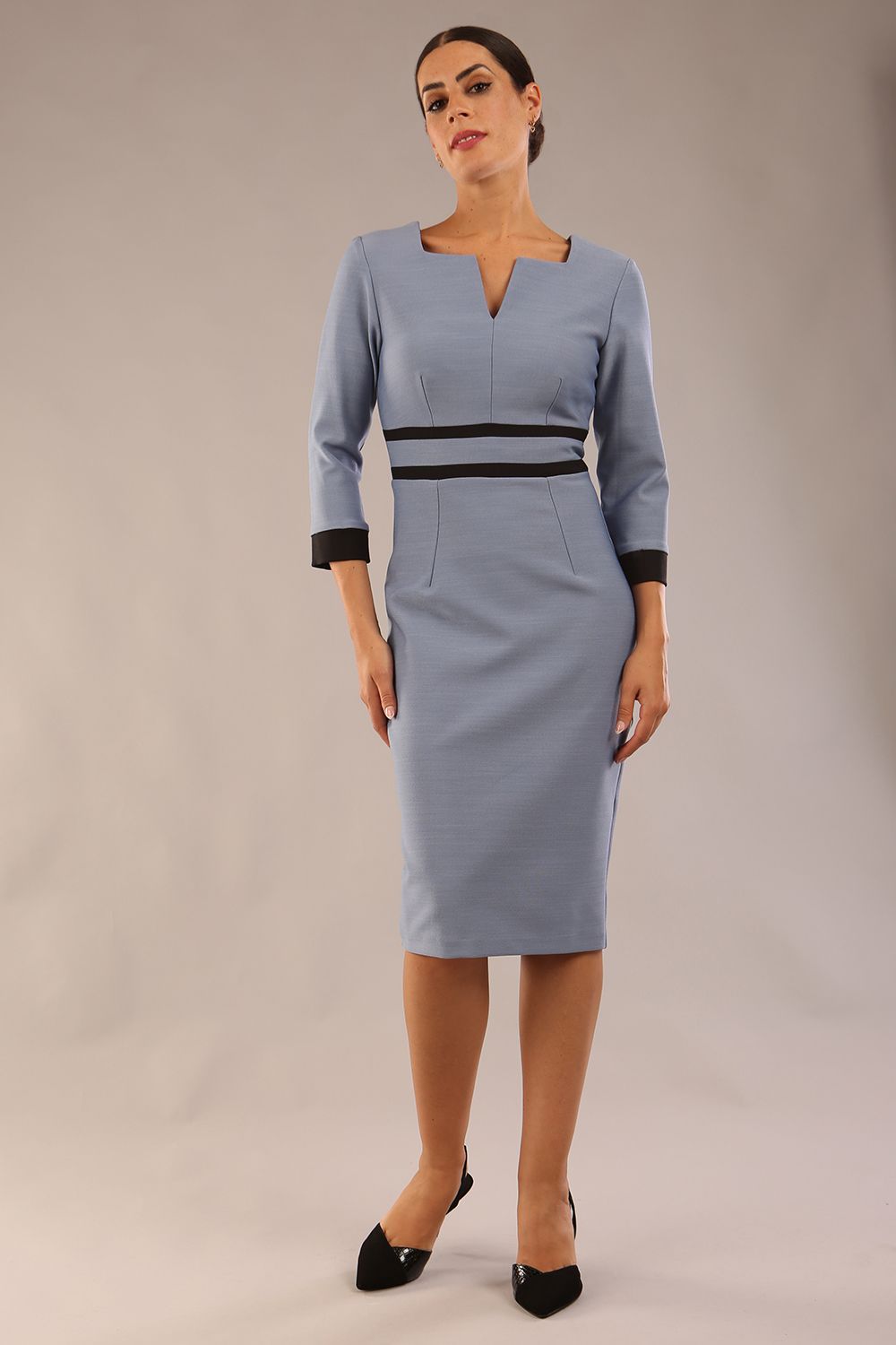 Model wearing Diva catwalk Paeonia dress square neckline with a vent in Pacific Green with Steel Blue and Black stripes around the waist and three quarter sleeve with black contrast finish front