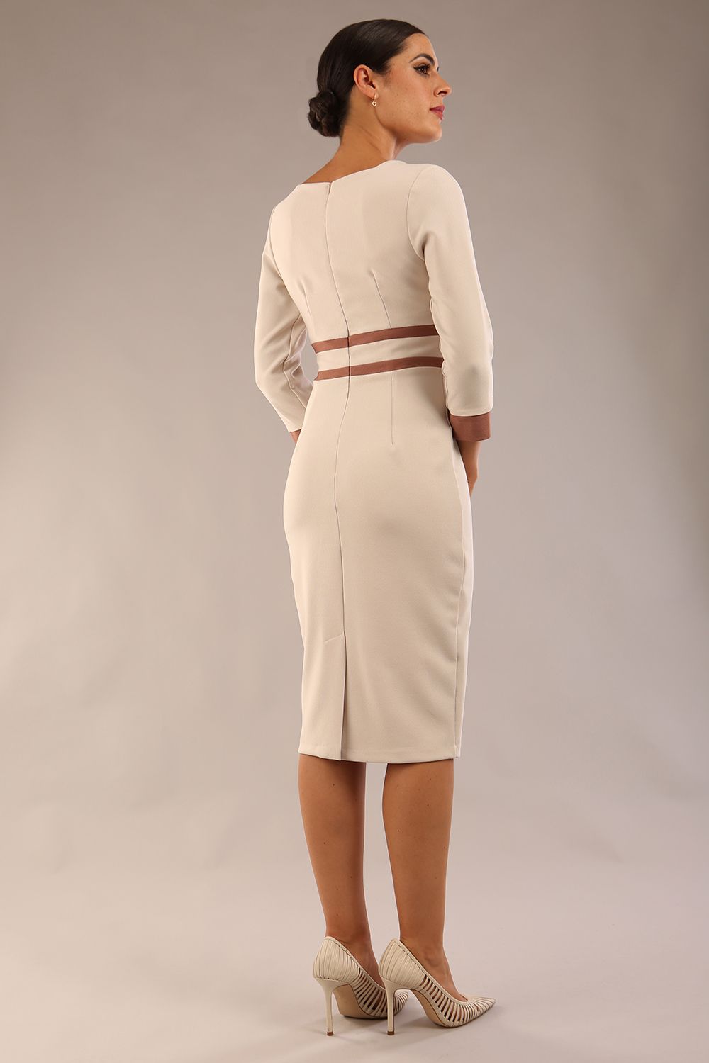 brunette model wearing Diva catwalk Paeonia dress square neckline with a vent in sandshell beige with Acorn Brown and sandshell beige stripes around the waist and three quarter sleeve with Acorn Brown contrast finish back