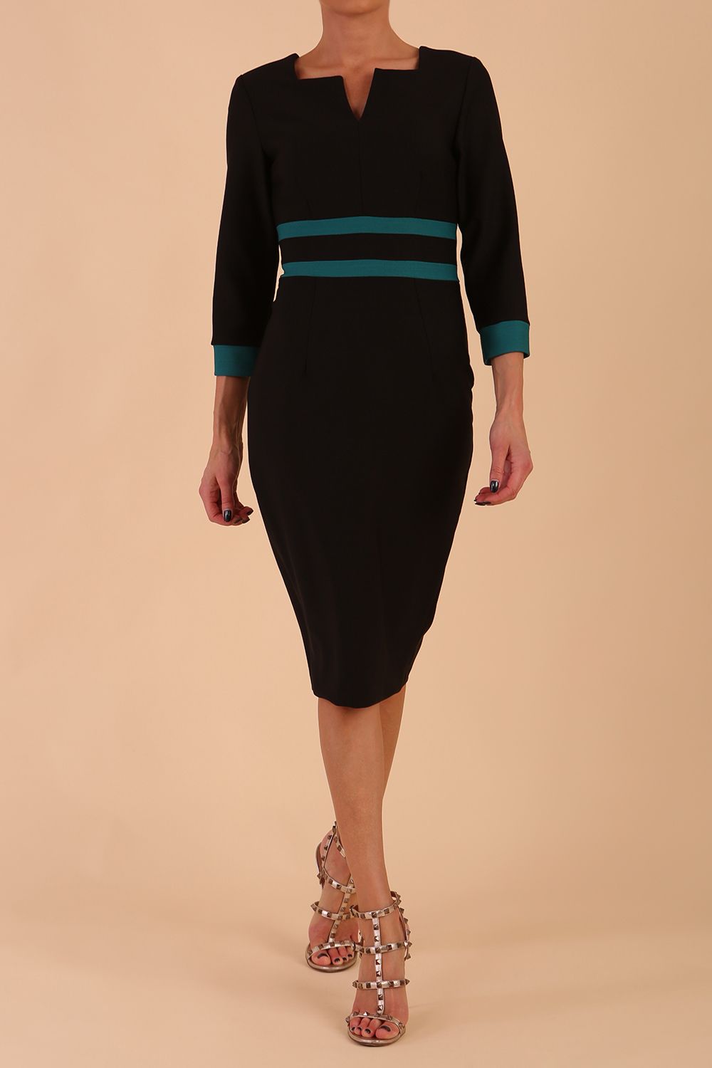 brunette model wearing Diva catwalk Paeonia dress square neckline with a vent in black with Pacific Green and black stripes around the waist and three quarter sleeve with Pacific Green contrast finish front
