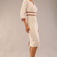 brunette model wearing Diva catwalk Paeonia dress square neckline with a vent in sandshell beige with Acorn Brown and sandshell beige stripes around the waist and three quarter sleeve with Acorn Brown contrast finish front side