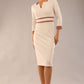 brunette model wearing Diva catwalk Paeonia dress square neckline with a vent in sandshell beige with Acorn Brown and sandshell beige stripes around the waist and three quarter sleeve with Acorn Brown contrast finish front