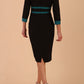 brunette model wearing Diva catwalk Paeonia dress square neckline with a vent in black with Pacific Green and black stripes around the waist and three quarter sleeve with Pacific Green contrast finish back