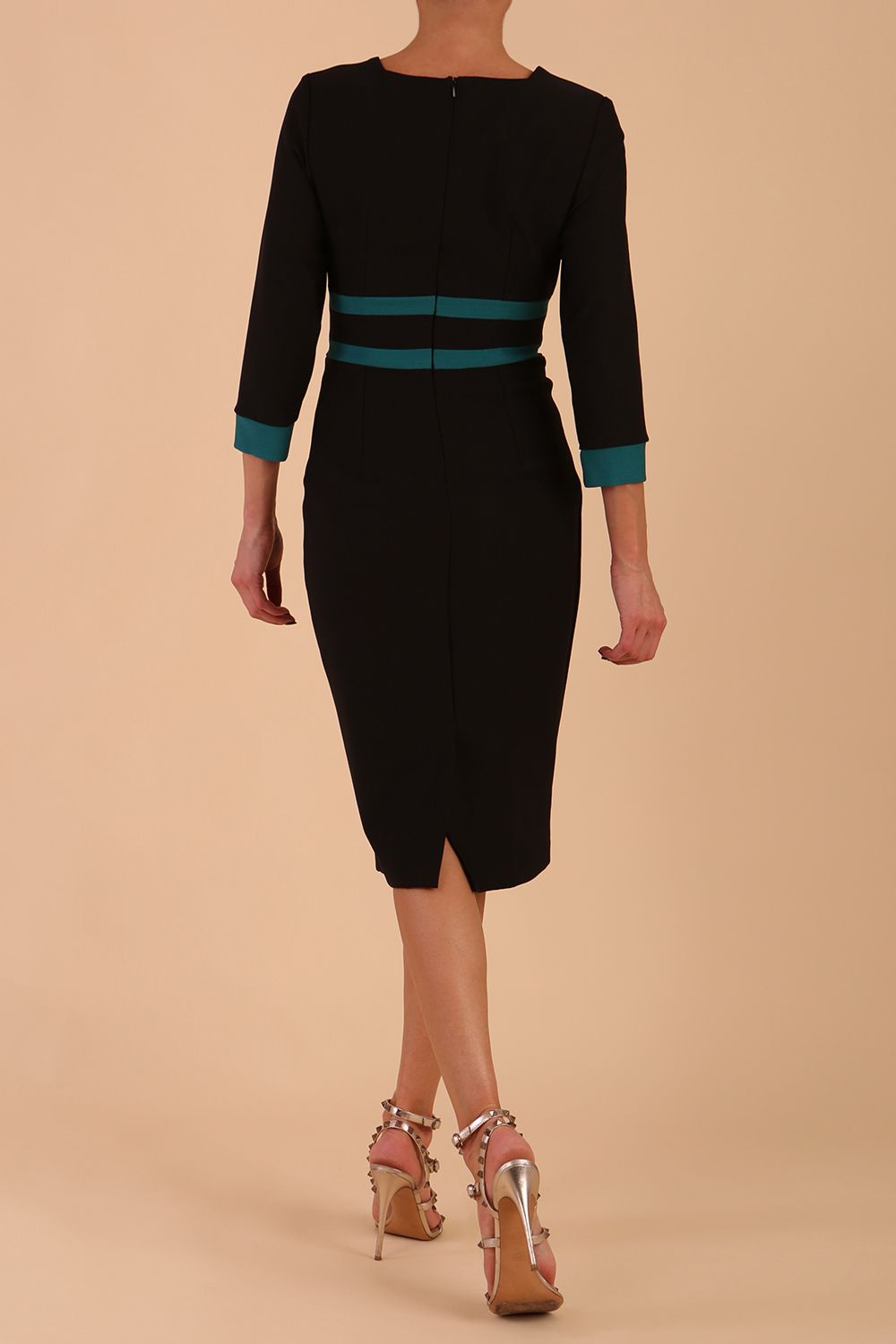 brunette model wearing Diva catwalk Paeonia dress square neckline with a vent in black with Pacific Green and black stripes around the waist and three quarter sleeve with Pacific Green contrast finish back