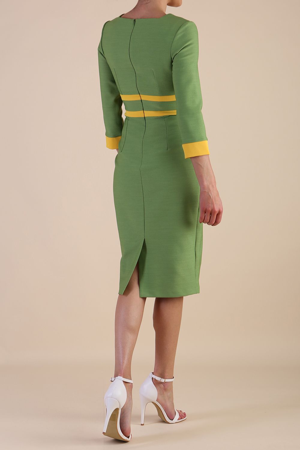 Model wearing Diva catwalk Paeonia dress square neckline with a vent in Citrus Green with Daffodil Yellow and Citrus Green stripes around the waist and three quarter sleeve with Daffodil Yellow contrast finish back