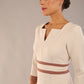 brunette model wearing Diva catwalk Paeonia dress square neckline with a vent in sandshell beige with Acorn Brown and sandshell beige stripes around the waist and three quarter sleeve with Acorn Brown contrast finish front close up