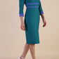 Model wearing Diva catwalk Paeonia dress square neckline with a vent in Pacific Green with Thistle Blue and Pacific Green stripes around the waist and three quarter sleeve with Thistle Blue contrast finish front side