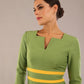 Model wearing Diva catwalk Paeonia dress square neckline with a vent in Citrus Green with Daffodil Yellow and Citrus Green stripes around the waist and three quarter sleeve with Daffodil Yellow contrast finish front close up