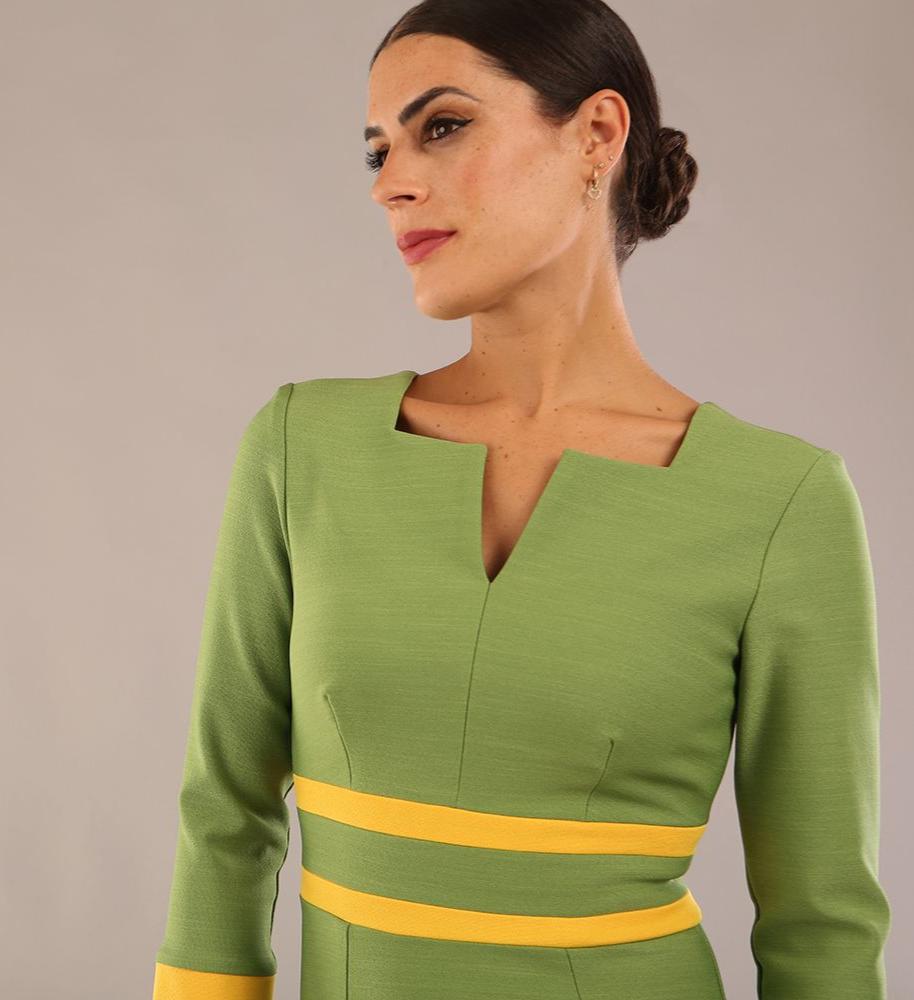 Model wearing Diva catwalk Paeonia dress square neckline with a vent in Citrus Green with Daffodil Yellow and Citrus Green stripes around the waist and three quarter sleeve with Daffodil Yellow contrast finish front close up