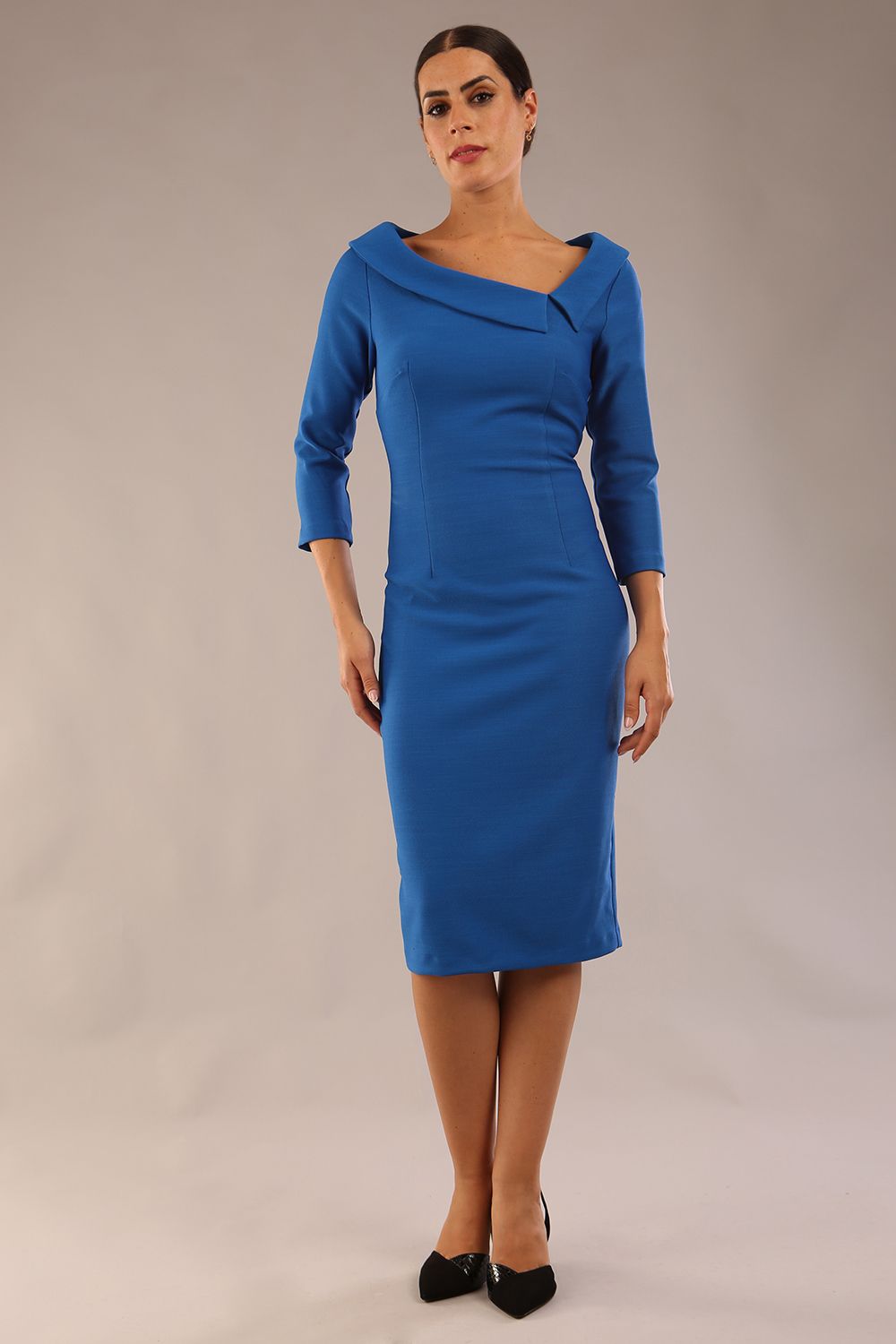 Model wearing Diva catwalk Opulus pencil dress in sapphire blue with three quarter sleeve figure fitted front image