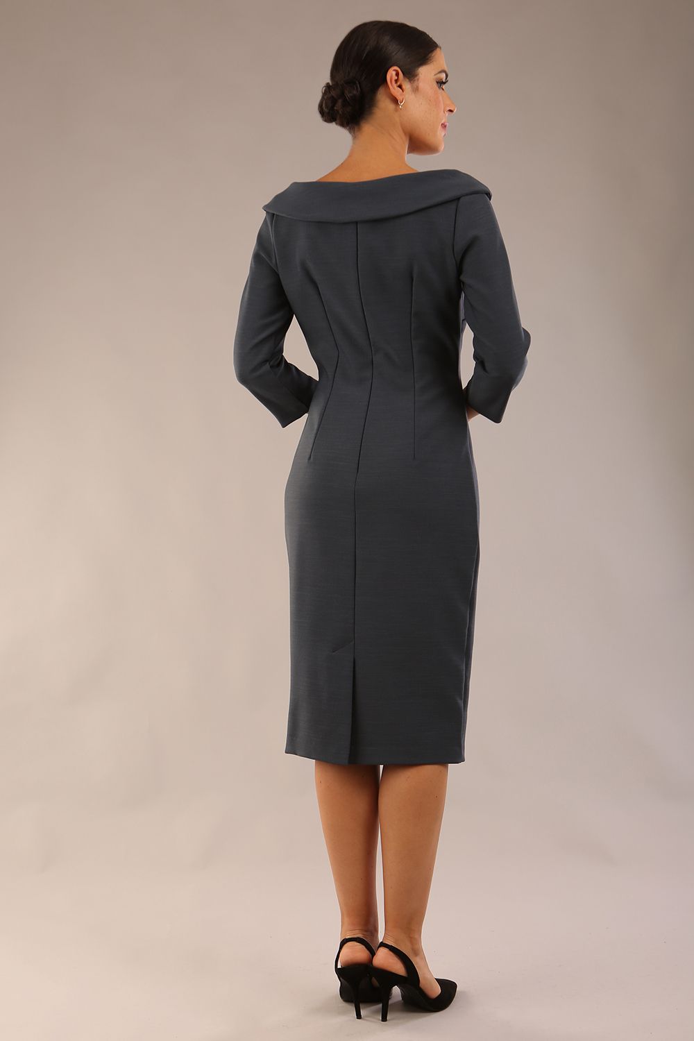 Model wearing Diva catwalk Opulus pencil dress in slate grey with three quarter sleeve figure fitted front image