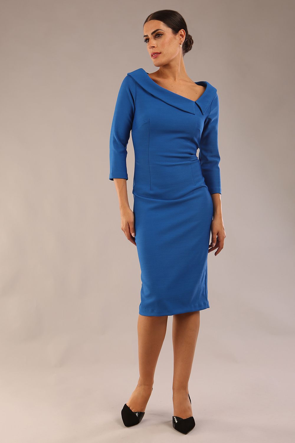 Model wearing Diva catwalk Opulus pencil dress in sapphire blue with three quarter sleeve figure fitted front image