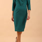 brunette model wearing diva catwalk cranston pencil-skirt dress with low v-neck and tie detail wide band with sleeves in pacific green colour front