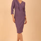 brunette model wearing diva catwalk cranston pencil-skirt dress with low v-neck and tie detail wide band with sleeves in dusty lilac colour 