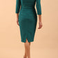 brunette model wearing diva catwalk cranston pencil-skirt dress with low v-neck and tie detail wide band with sleeves in pacific green colour back