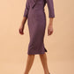 brunette model wearing diva catwalk cranston pencil-skirt dress with low v-neck and tie detail wide band with sleeves in dusty lilac colour front