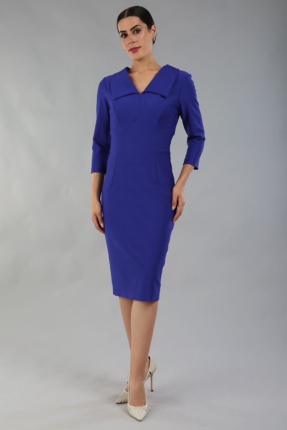 Model wearing Diva catwalk Pieris pencil dress in palace blue with three quarter sleeve figure fitted black image