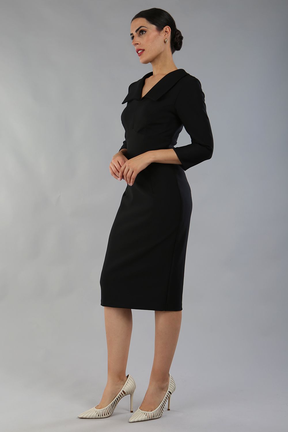 Model wearing Diva catwalk Pieris pencil dress in black with three quarter sleeve figure fitted front image