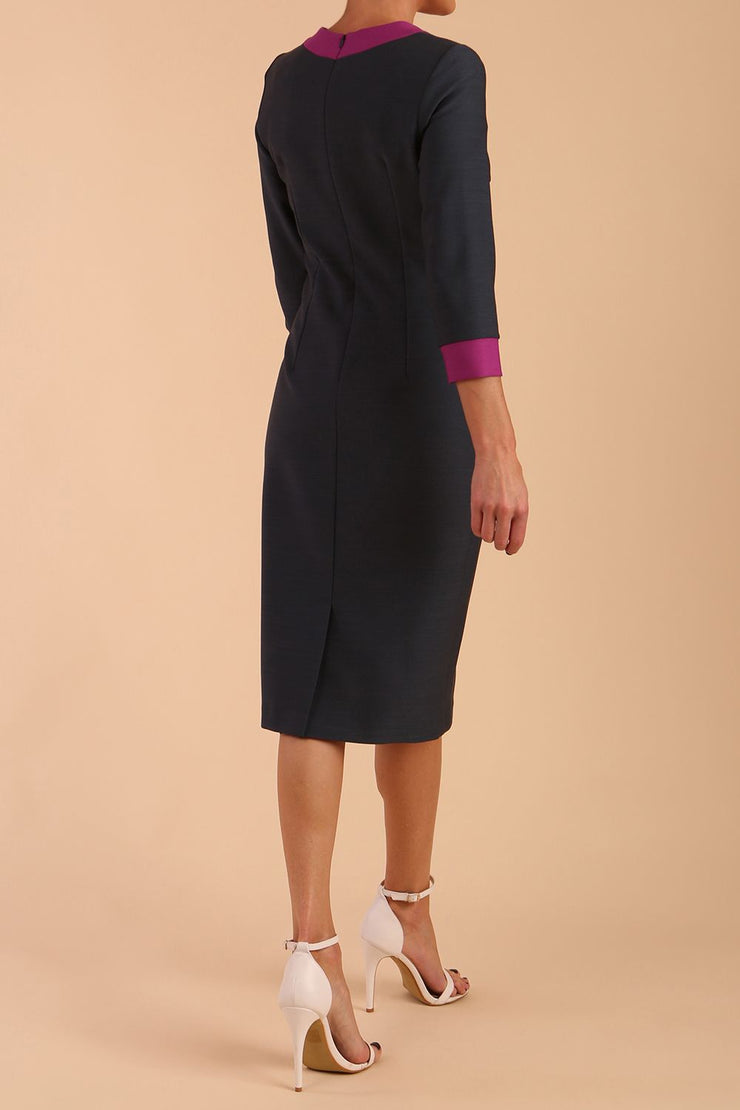 Model wearing Diva catwalk Branwen pencil figure fitted dress in slate grey with three quarter sleeve and dawn purple contrast detail front image
