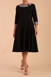 Model wearing Diva catwalk Coralia swing dress in black/ slate grey with three quarter sleeve figure fitted front image